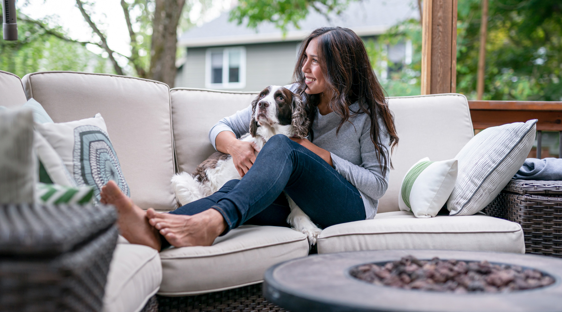 Young woman and dog relaxing on couch