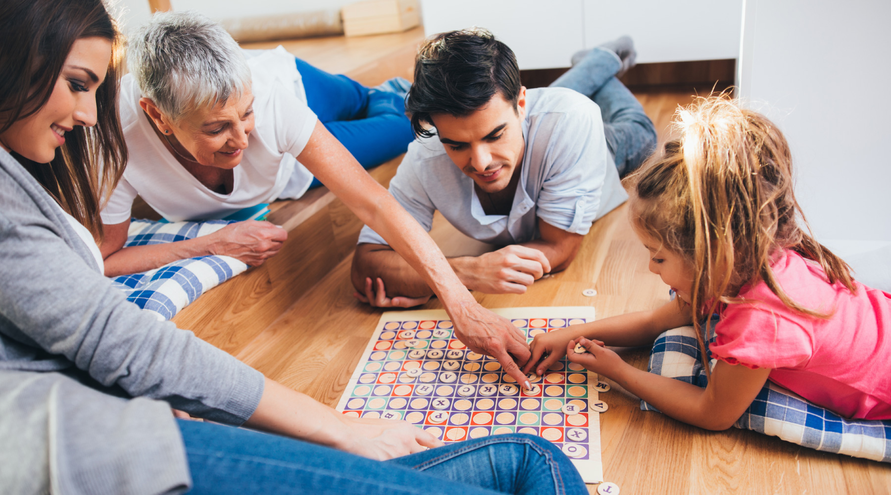 Family on floor playing games at Melia Homes