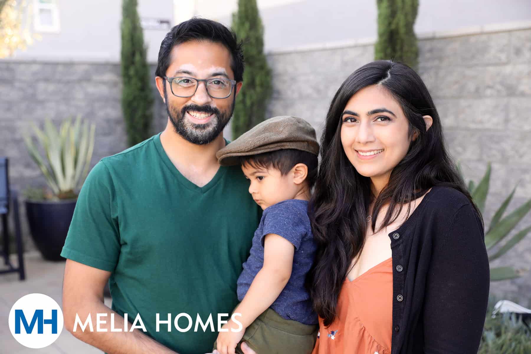 Family with young child pose together at Homeowner Happy Hour at One Seven Eight by Melia Homes