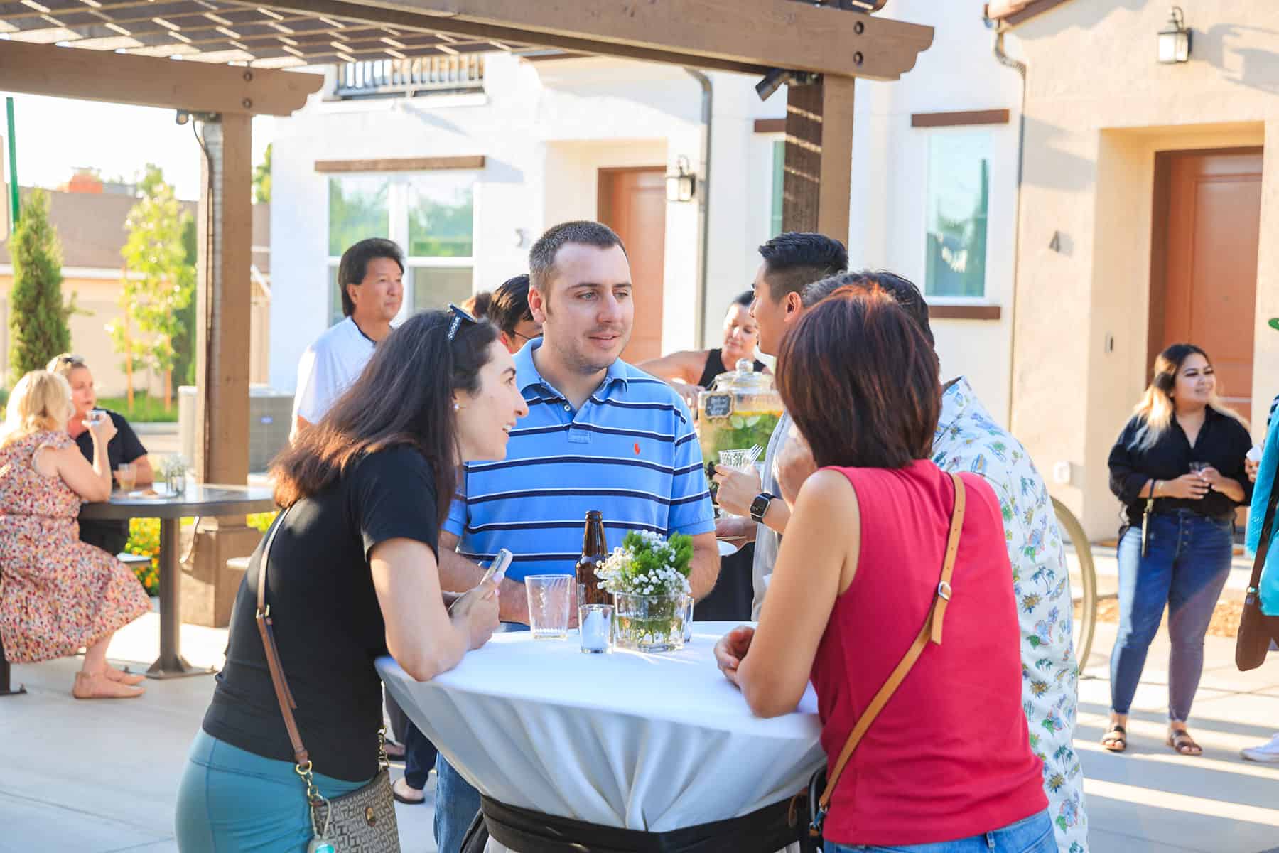 People socializing at Homeowner Happy Hour for Townes at Broadway and Townes at Magnolia by Melia Homes in Anaheim, CA
